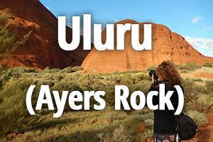 Uluru title with Maya taking a photo of Ayers Rock (Uluru) in the background